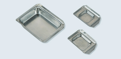 Three metal trays are displayed: one large rectangular tray and two smaller rectangular trays. The trays have smooth surfaces and raised edges, suitable for holding food or other items.