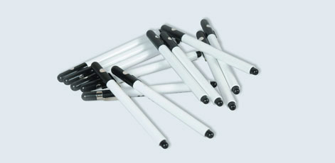 A scattered group of black and white pens is displayed, arranged at various angles on a light background. The pens have a sleek, cylindrical shape with black tips and caps, conveying a casual, creative theme.